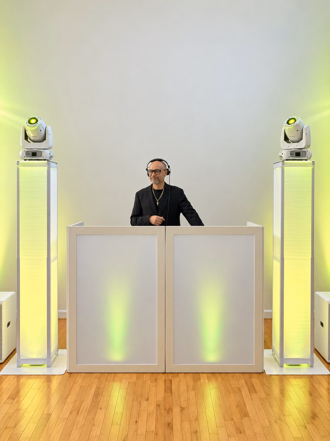 DJ EV in headphones behind the booth