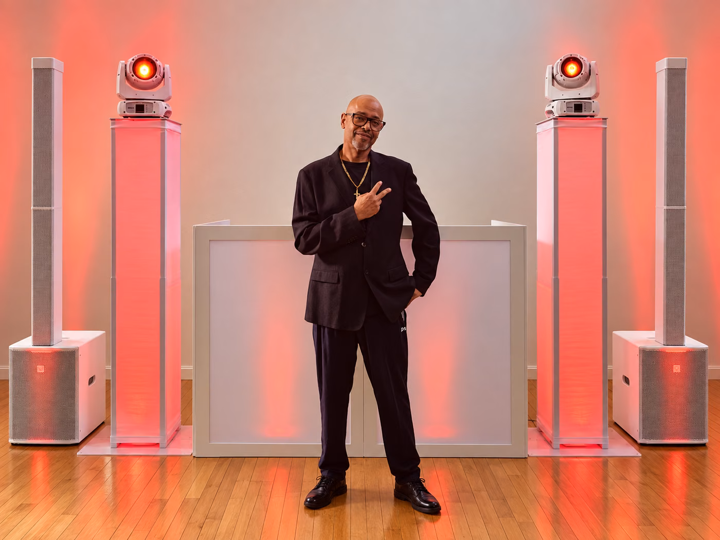 DJ EV in front of the booth with red lighting